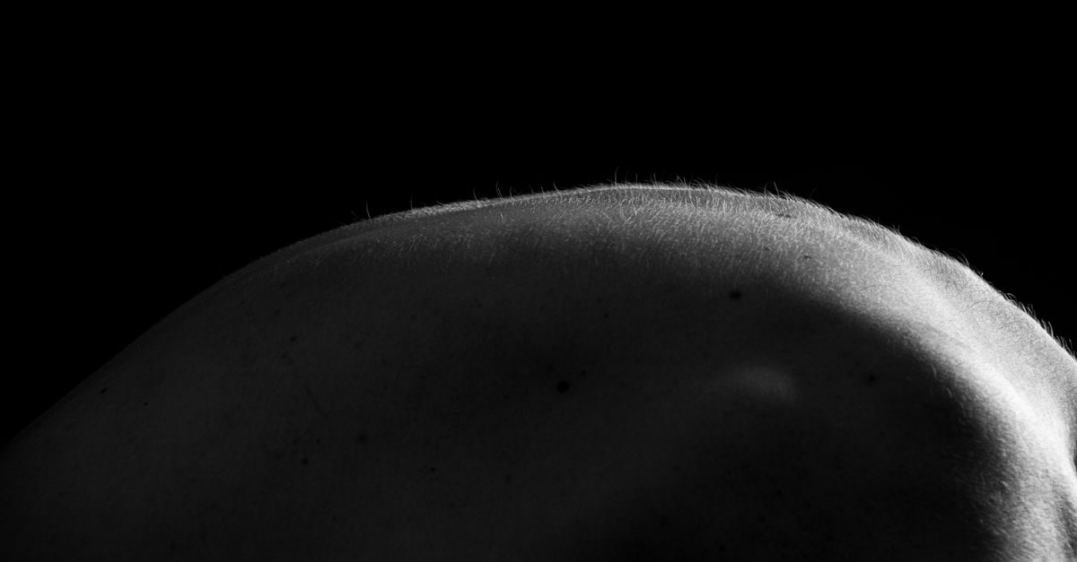Artistic capture of a human body's silhouette in black and white, emphasizing form.